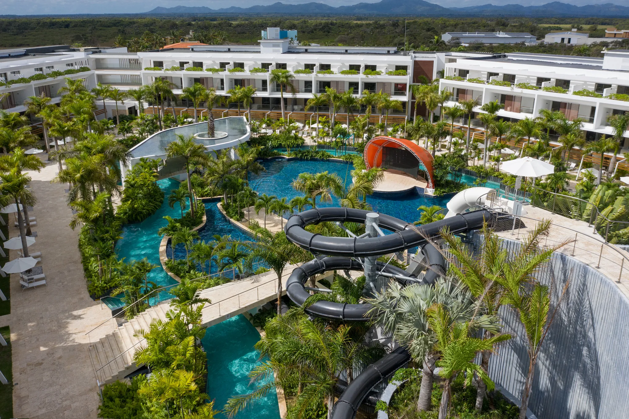 Aerial view of jungle-themed water park with slides and lazy river at Dreams Onyx Resort & Spa.