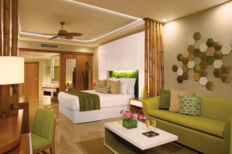 Dreams Onyx Resort Junior Suite with king bed, sofa seating area, and modern tropical décor.
