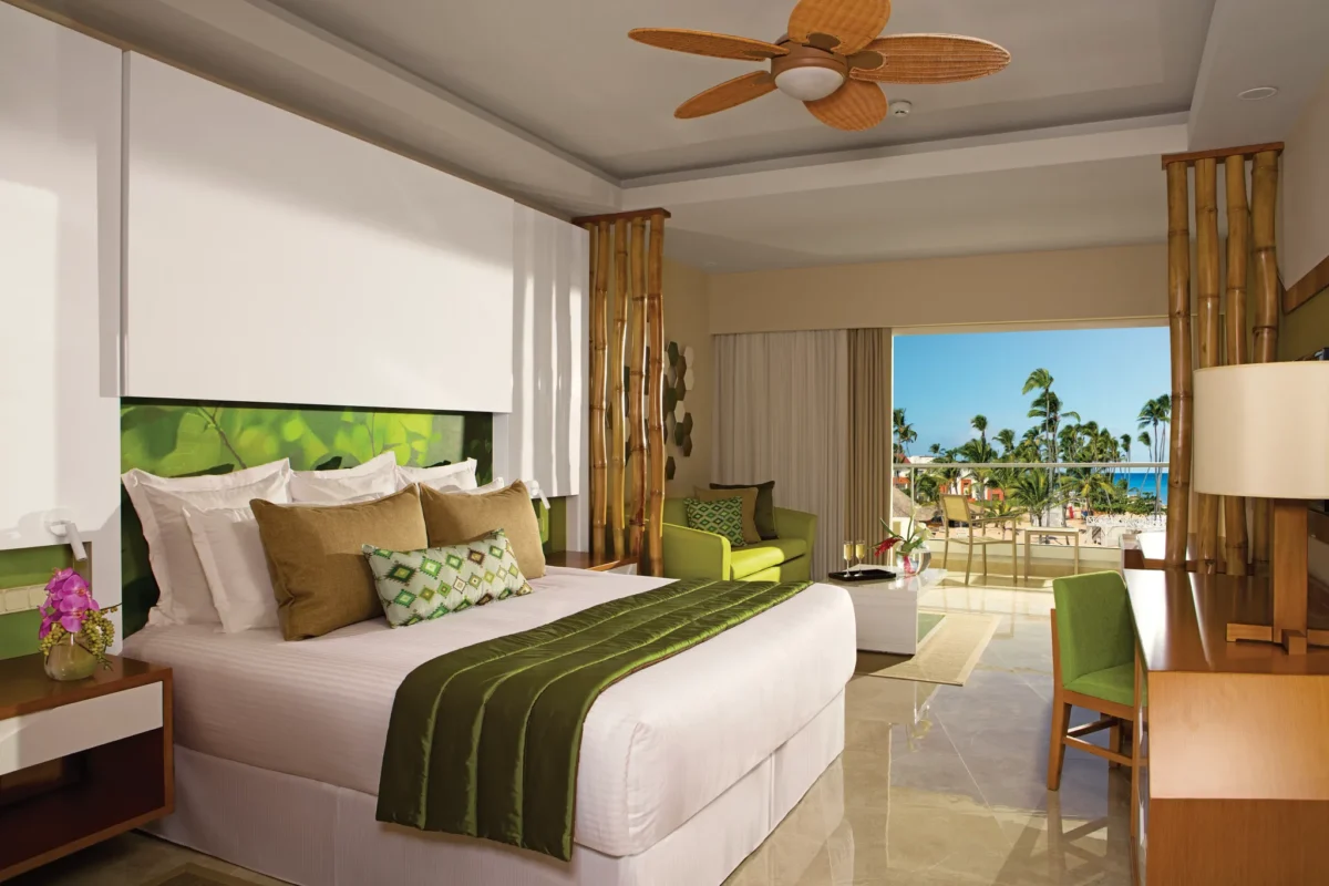 Preferred Club Junior Suite Partial Ocean View with king bed and balcony overlooking the ocean at Dreams Onyx Resort & Spa.