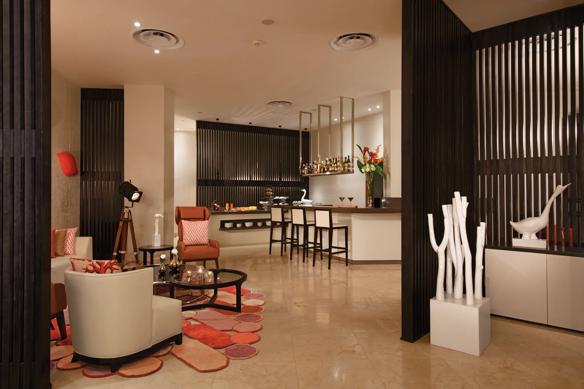 Upscale Preferred Club lounge with bar seating and modern décor at Dreams Onyx Resort & Spa.