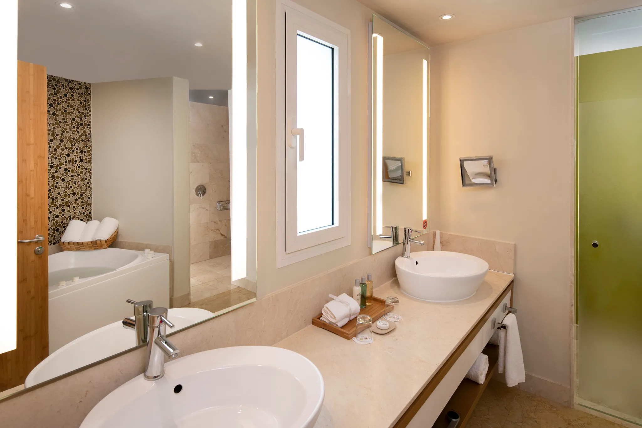 Modern bathroom with double sinks and soaking tub in Preferred Club Presidential Suite at Dreams Onyx Resort & Spa.