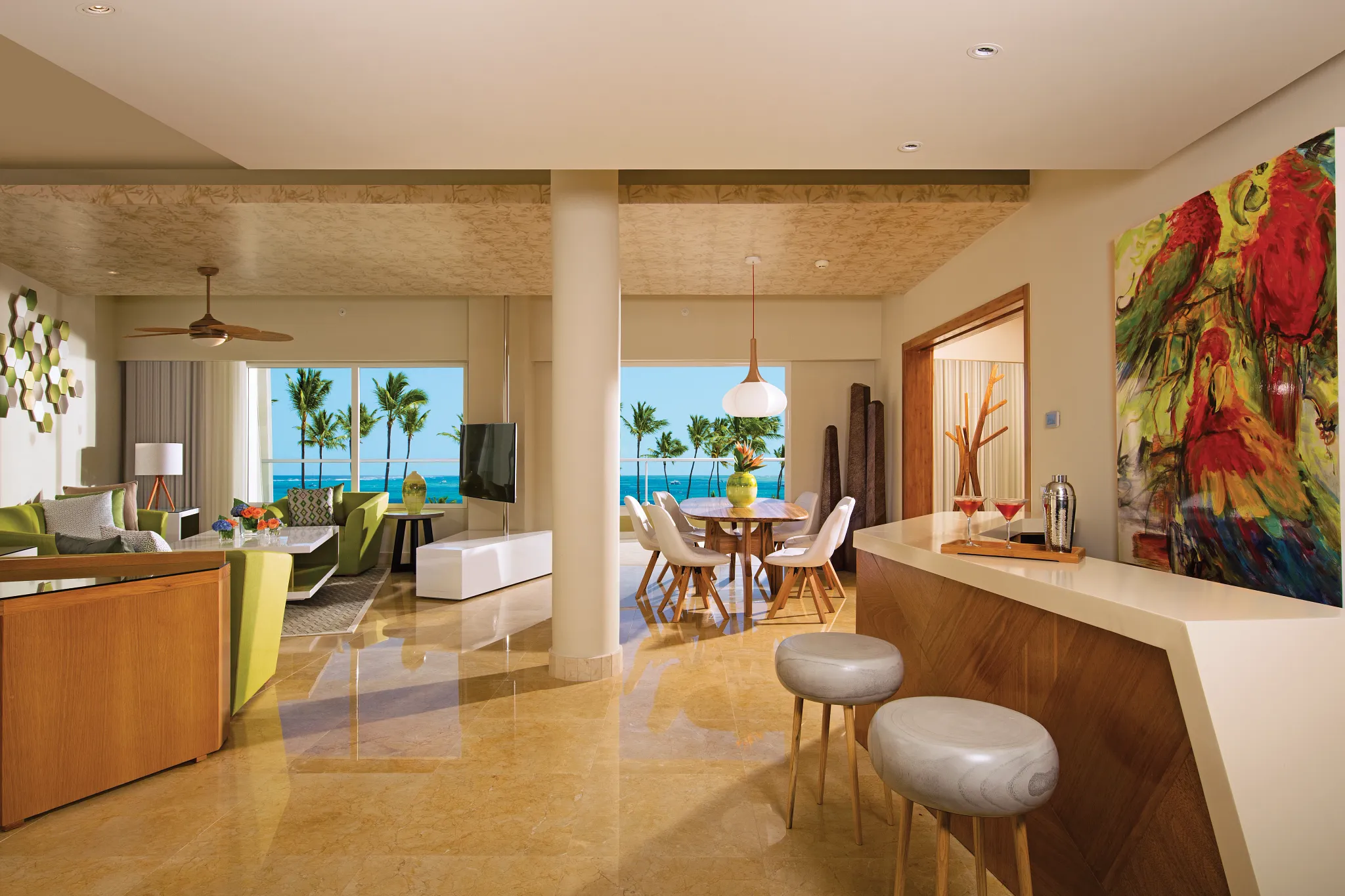 Living and dining area with ocean view in Preferred Club Presidential Suite at Dreams Onyx Resort & Spa.