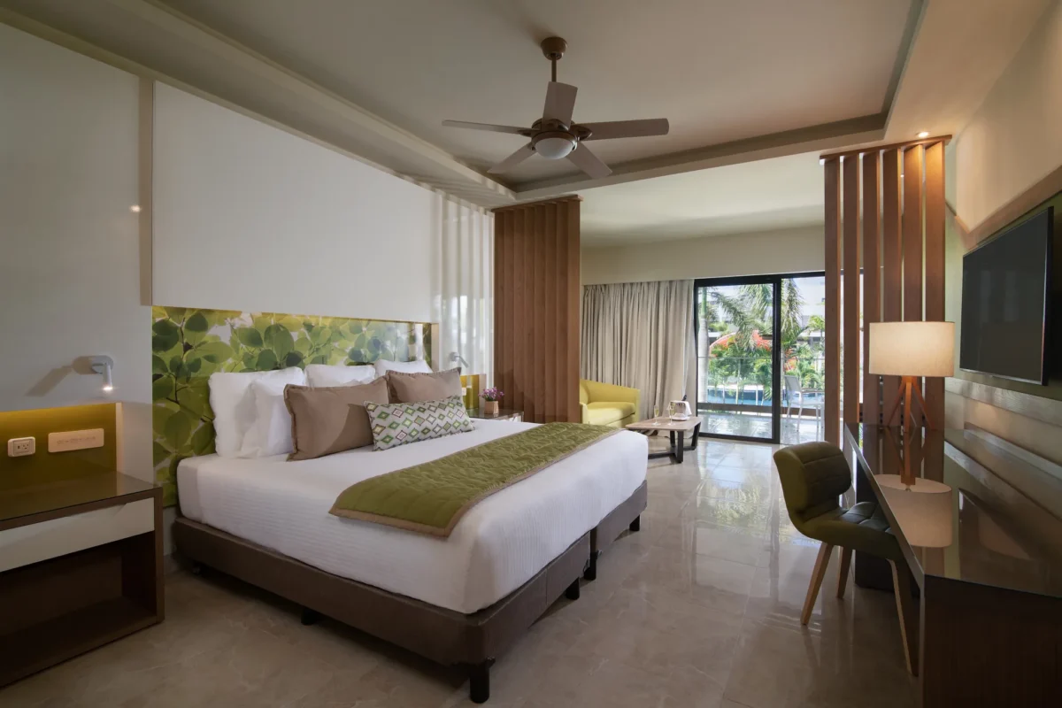 Premium Junior Suite Pool View with king bed and balcony at Dreams Onyx Resort & Spa.
