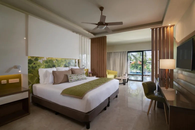 Premium Junior Suite Pool View with king bed and balcony at Dreams Onyx Resort & Spa.