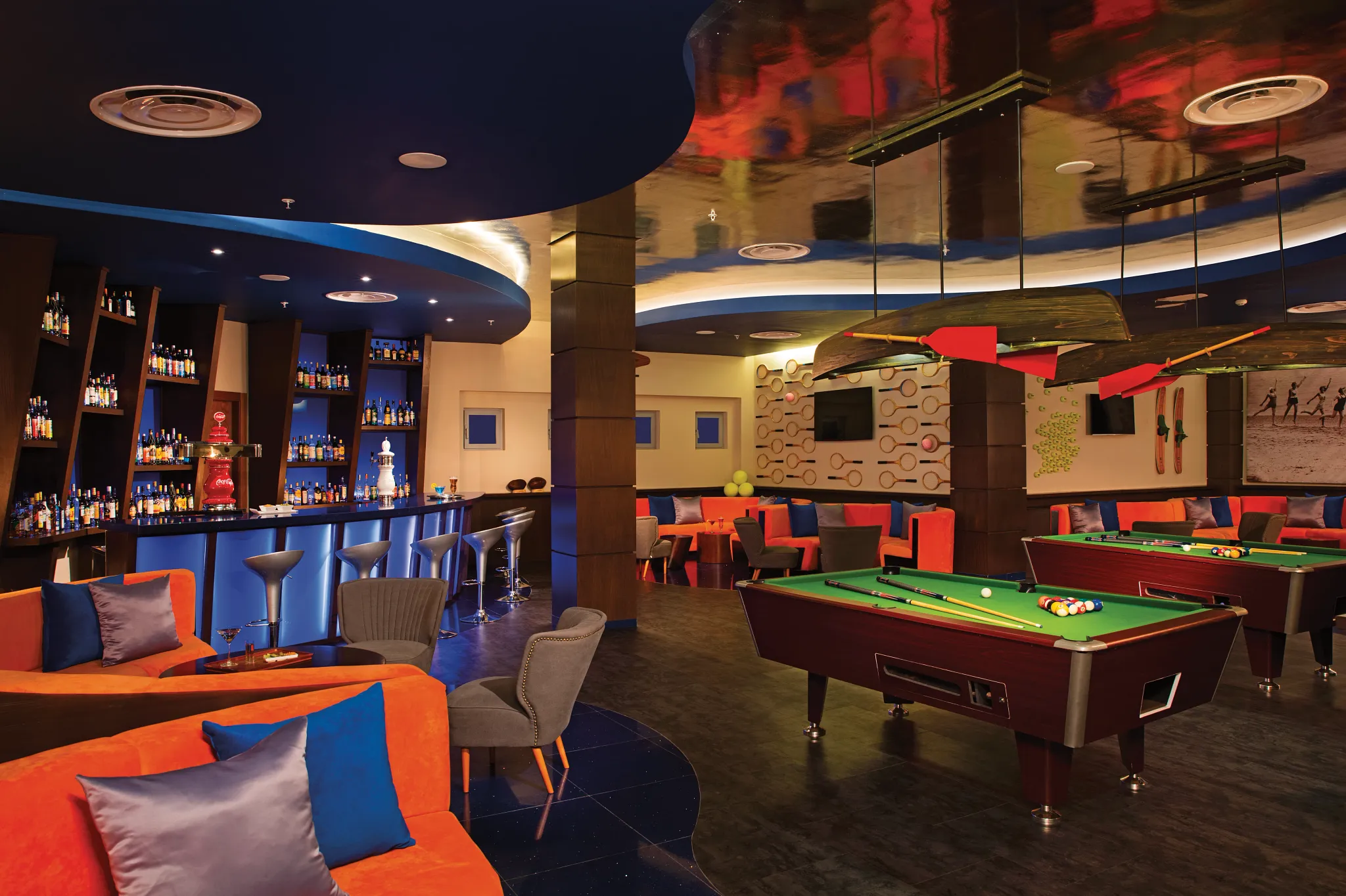 Scores Sports Bar at Dreams Onyx Resort & Spa featuring multiple TVs, casual seating, and a lively atmosphere for watching games.