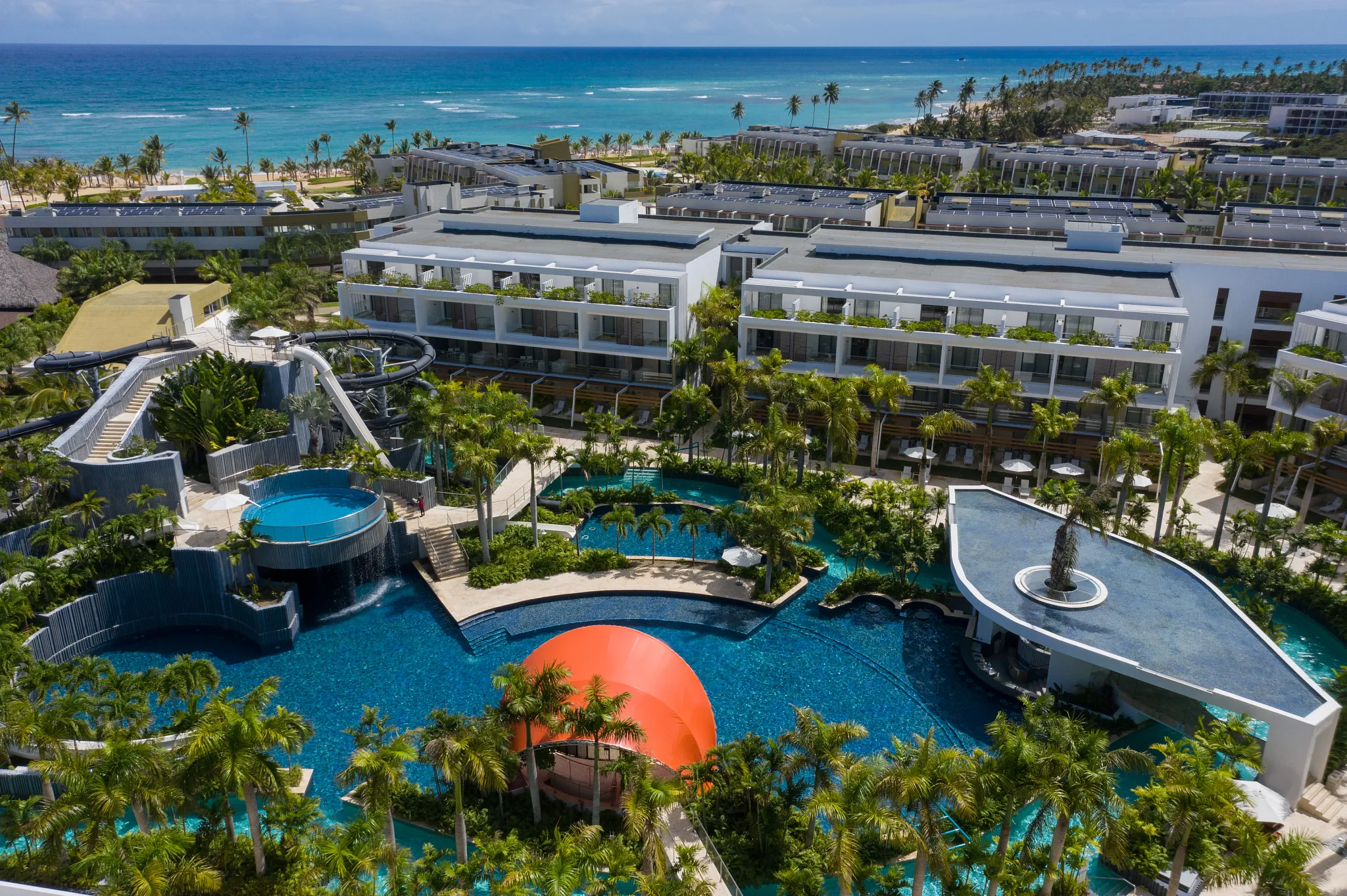 Resort water park with multiple slides, pools, and tropical landscaping at Dreams Onyx Resort & Spa.