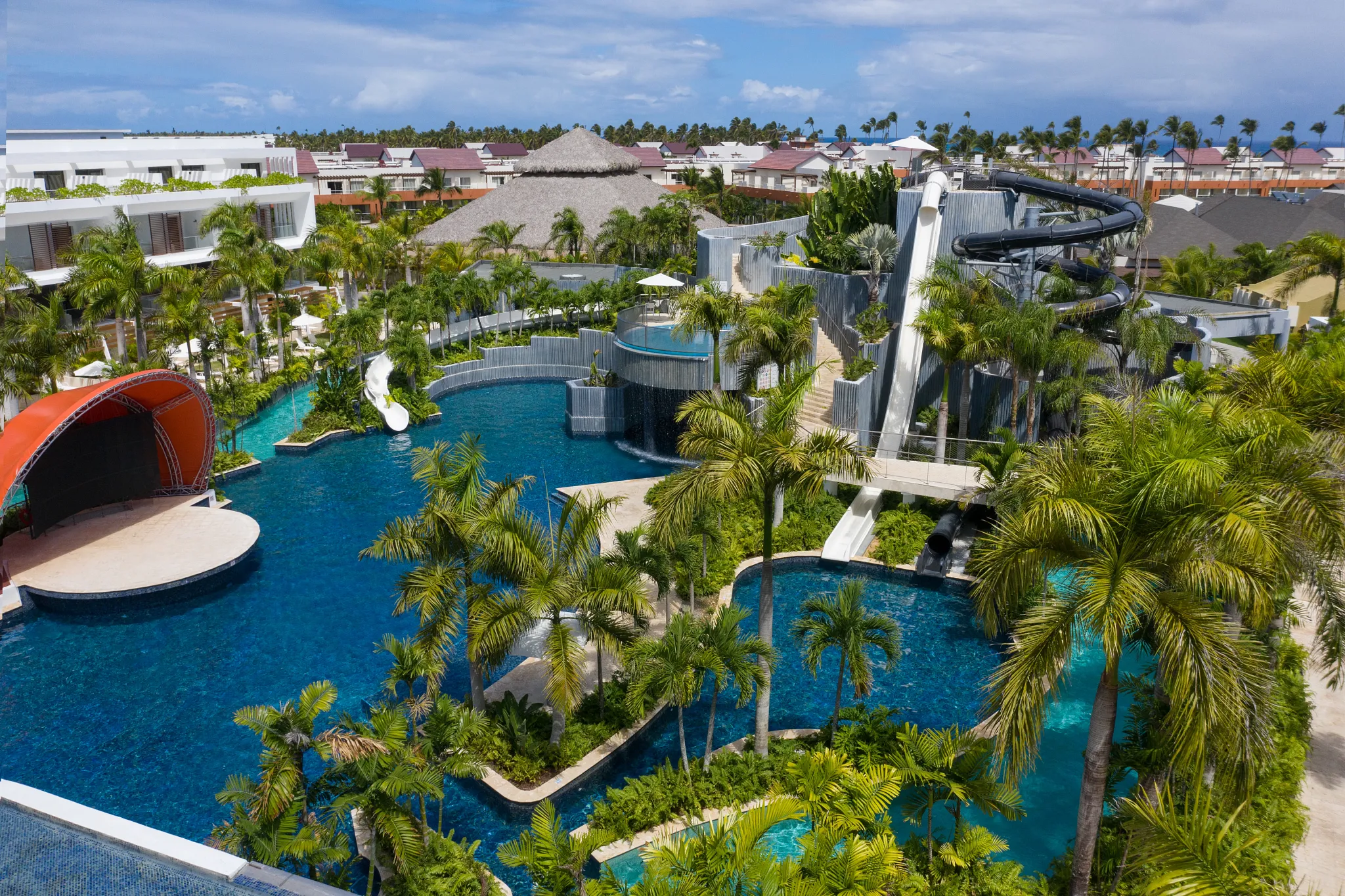 Resort pool with waterfall feature and water slides at Dreams Onyx Resort & Spa.